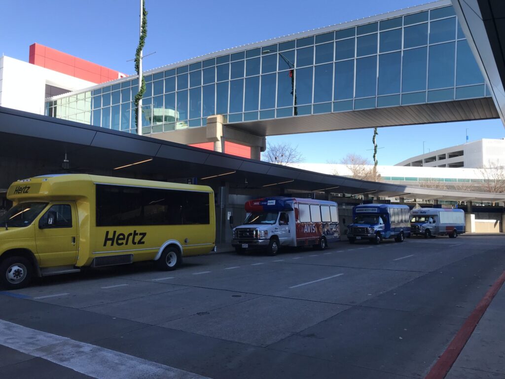 free shuttle bus with Hertz logo to car rental center Dallas Love Field airport DAL