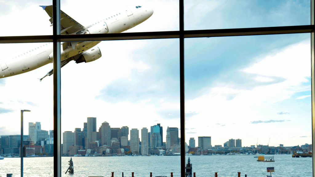 view of a plane taking off from a large window