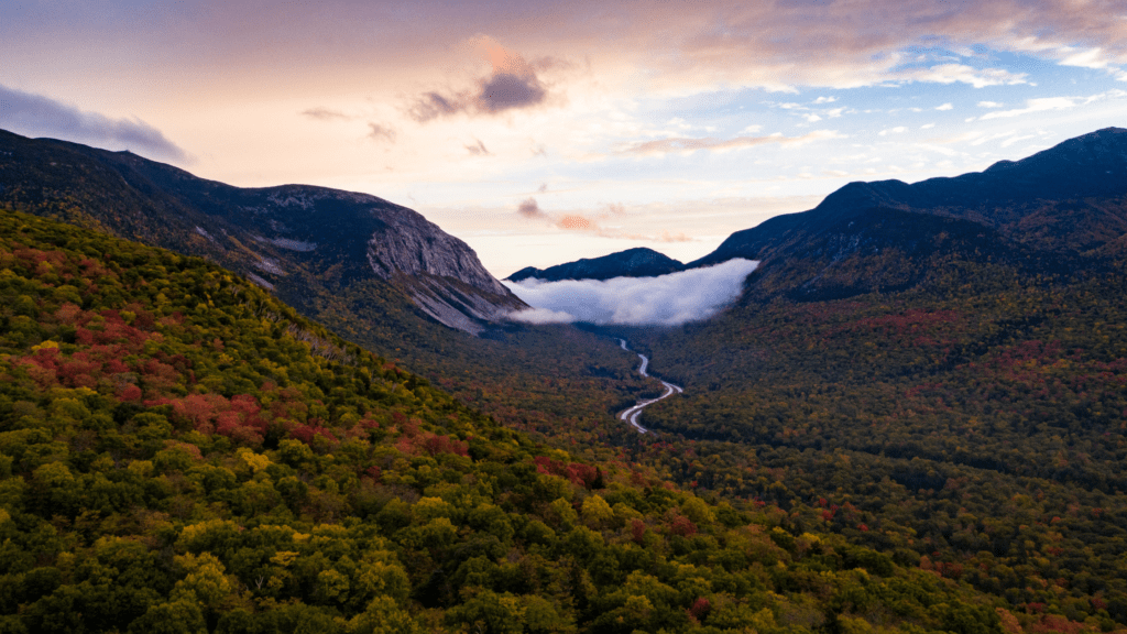 scenic fall image of a road in a mountain forest representing fall travel ideas