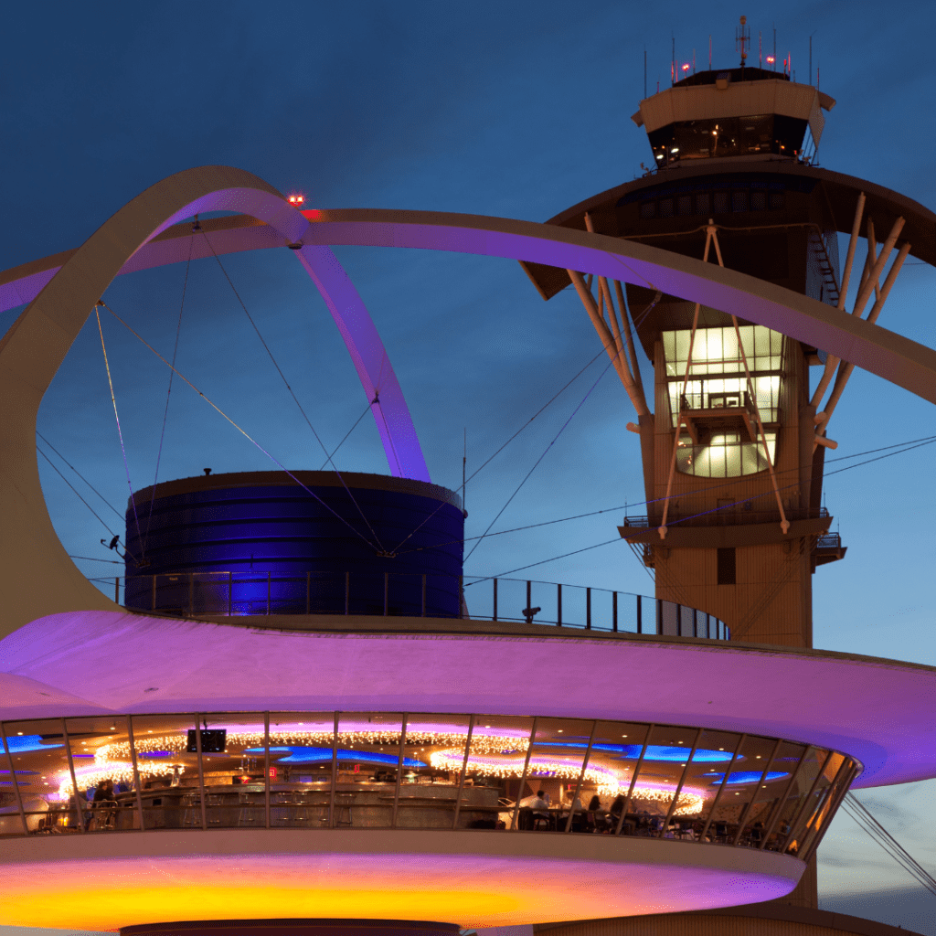 image of the tower at LAX airport and a terminal in the evening