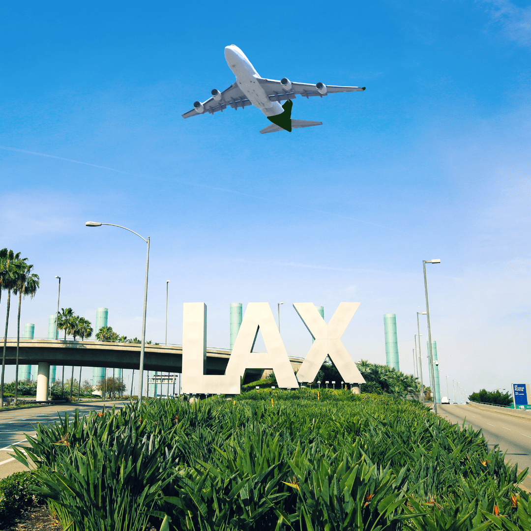 image of an airplane flying over the LAX airport sign