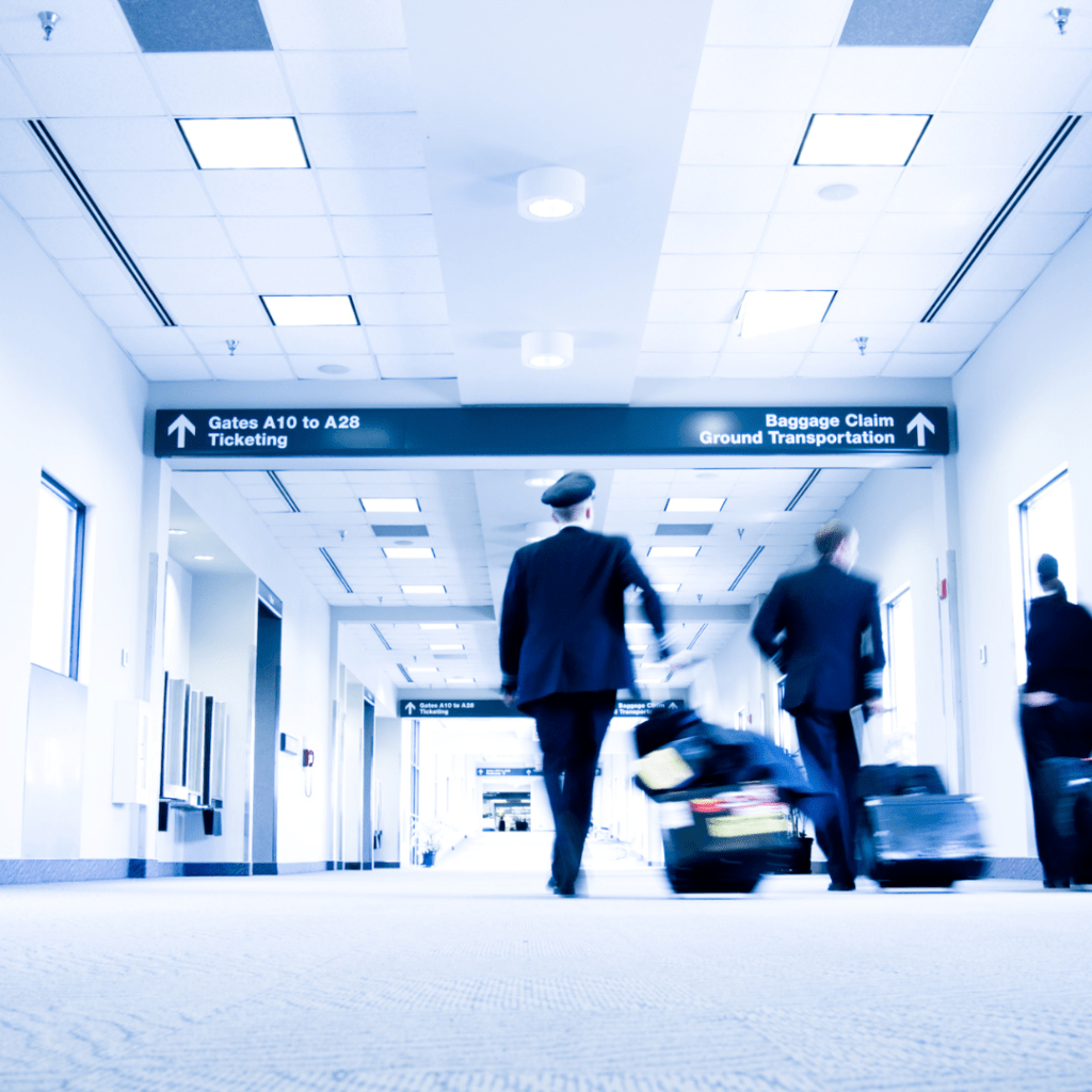 a flight crew walking through RDU airport towards baggage claim