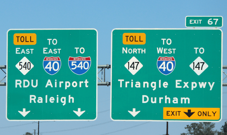 two highway signs in North Carolina showing the location of 540, I 40 and 147. The Triangle Expressway to Durham and to RDU airport in Raleigh
