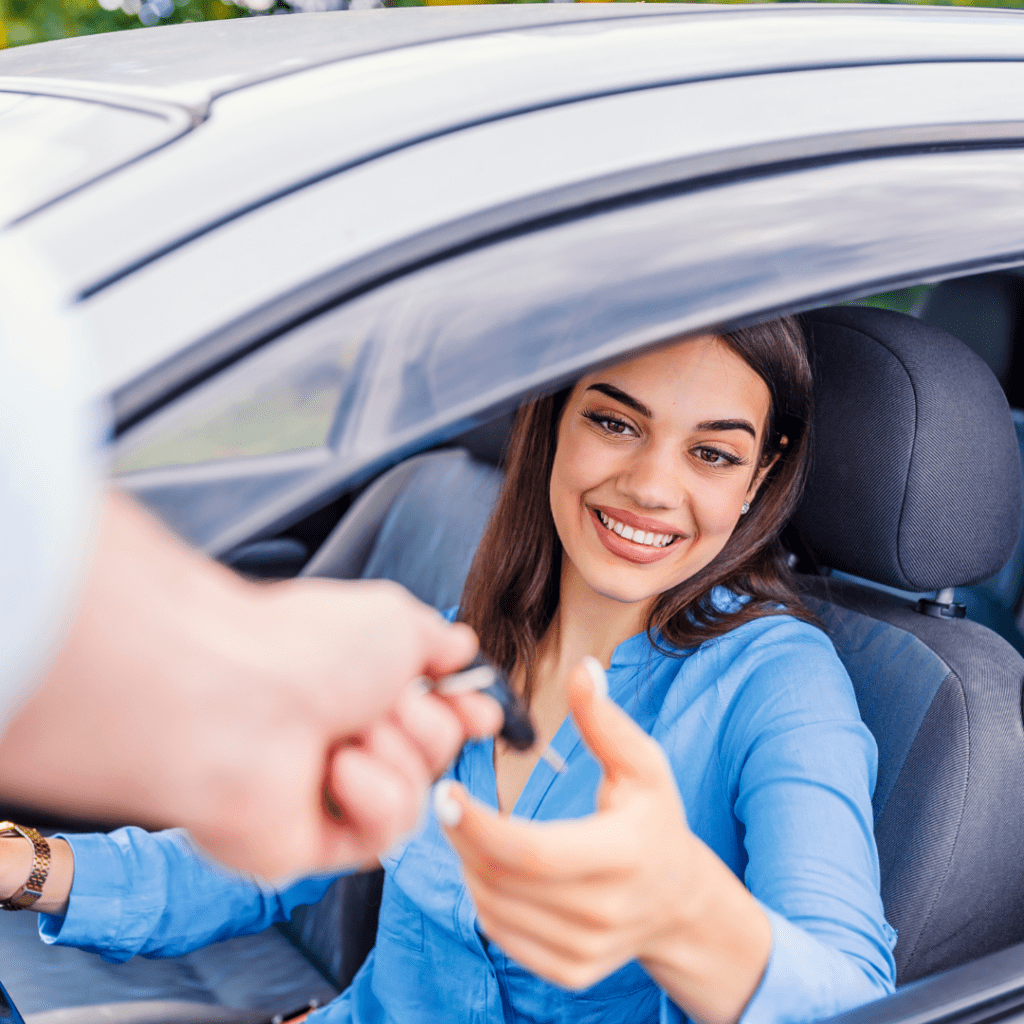 person receiving the keys to their rental car