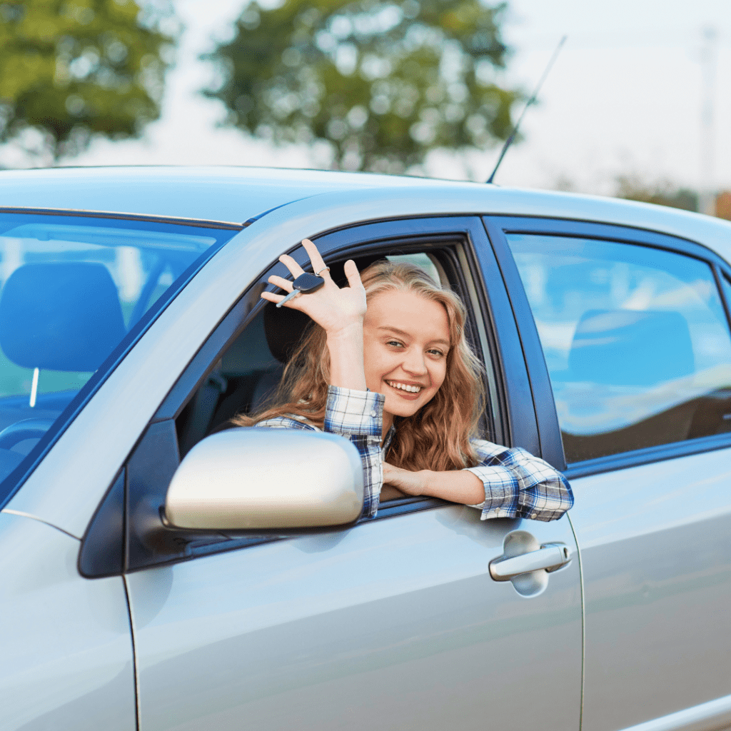 image of a person smiling in a rental car