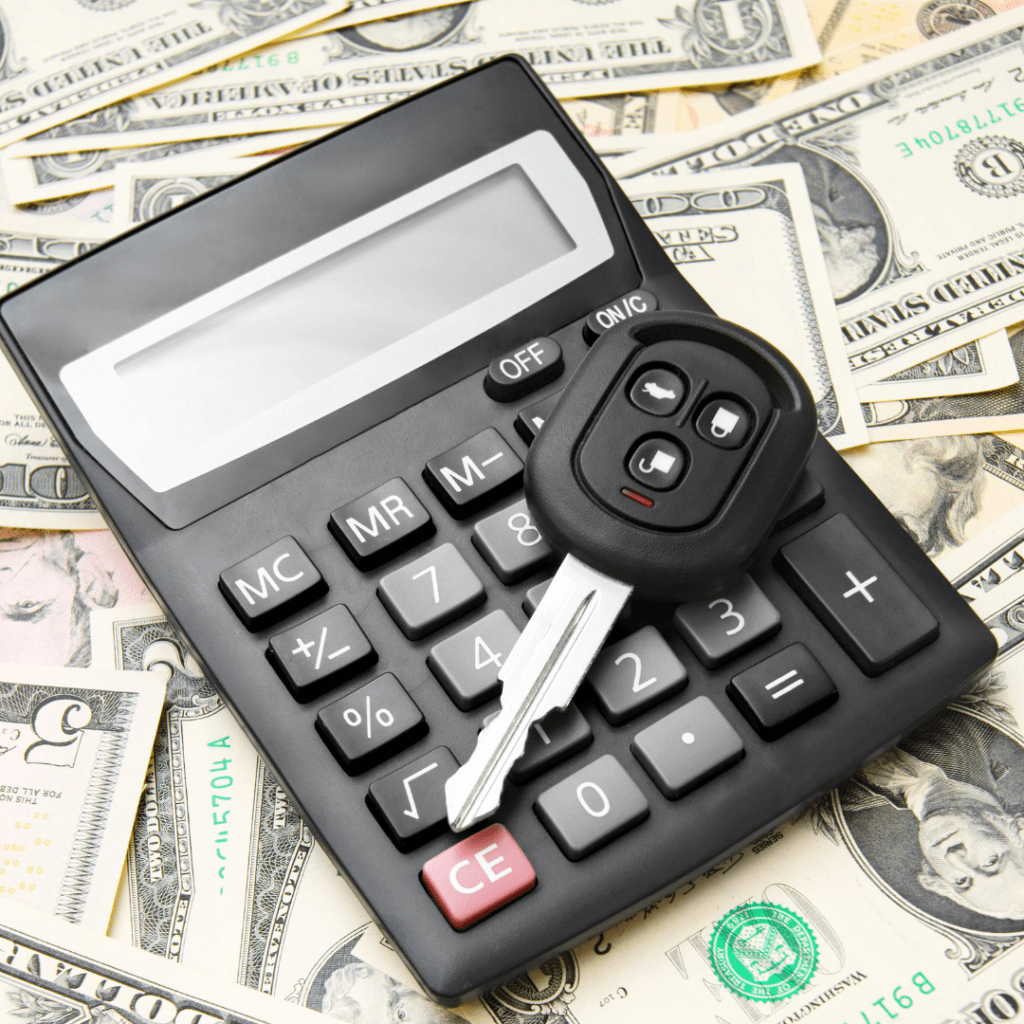 a calculator and money with a car key resting on top of it representing car fees