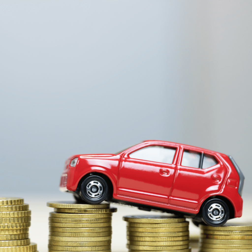 image of a toy car driving on money representing fees