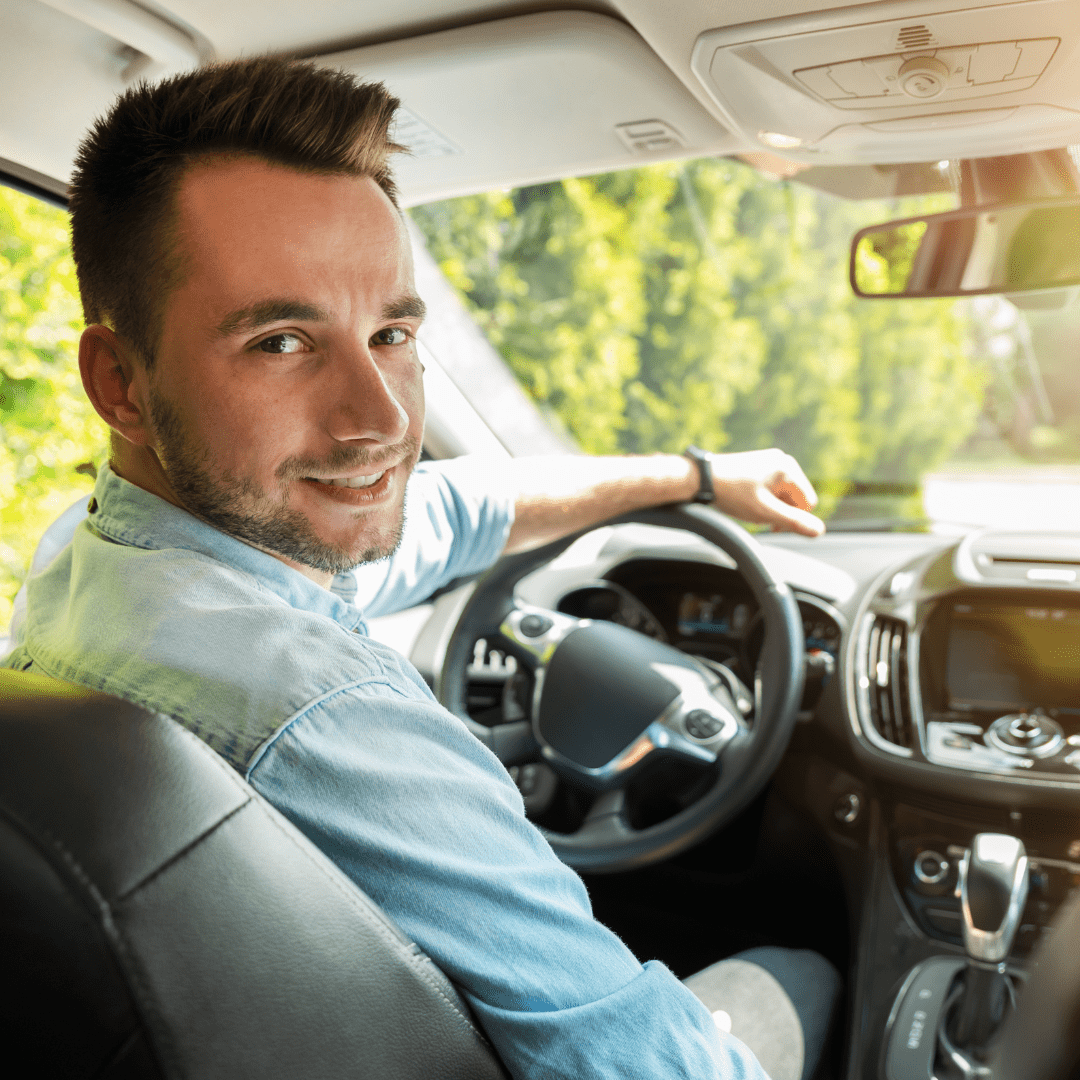 young man driving a car