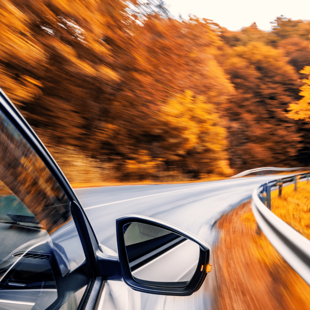 a car driving on a Fall Foliage Road Trip