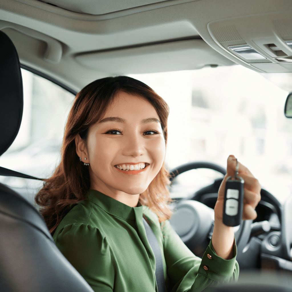 image of a smiling businesswoman holding rental car keys after choose the right rental car for a business trip