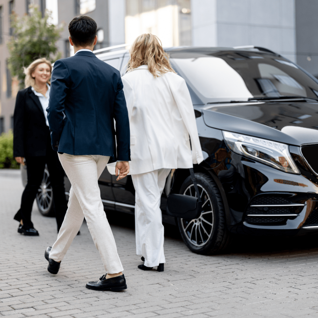 image of three business people near an SUV being used for a business trip