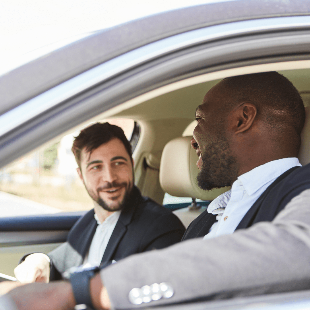 two people in suits in a car representing how to choose the right car for business travel