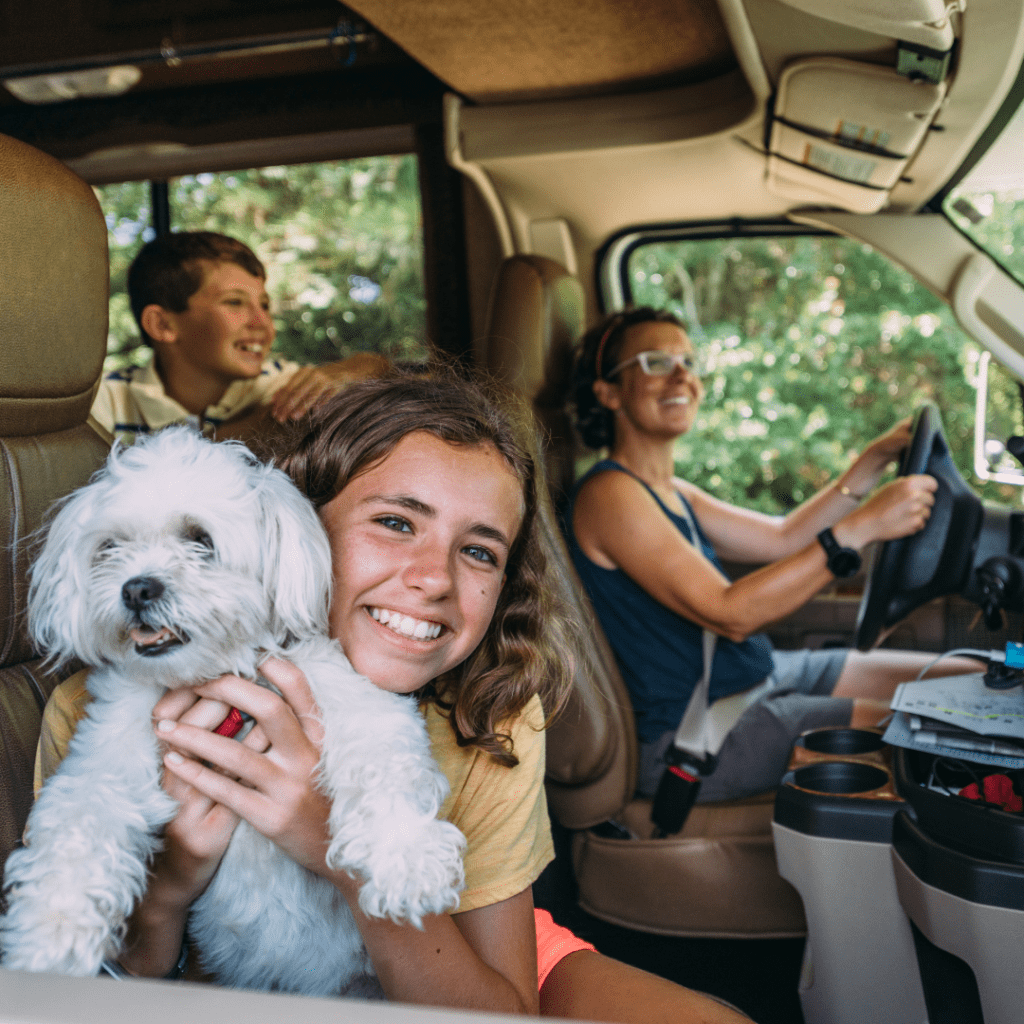 happy family with a dog on a family friendly road trip