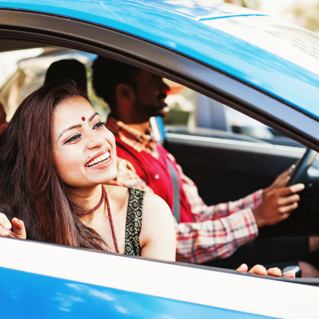 Indian family in a car  representing renting a car in the U.S.