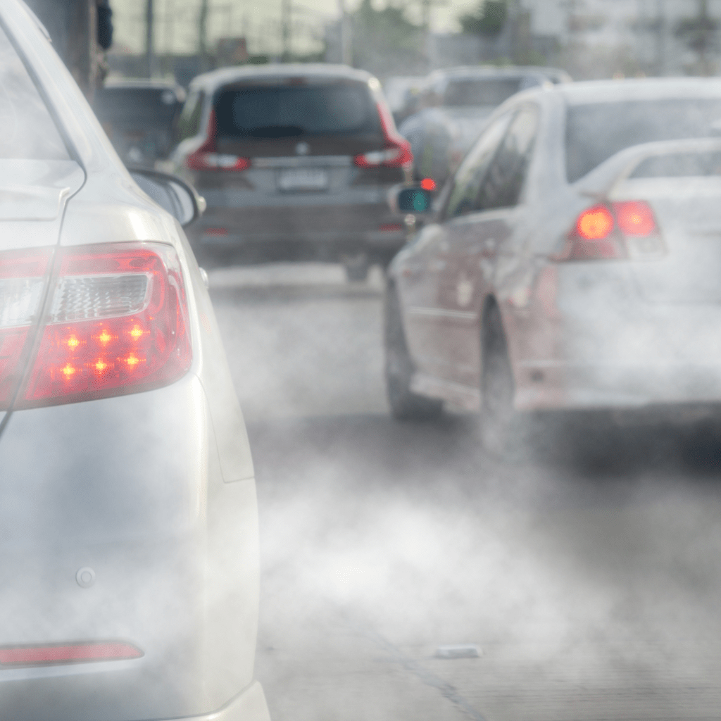 image of a several cars emitting pollution displaying the environmental impact of a ride share waiting to pick up passengers